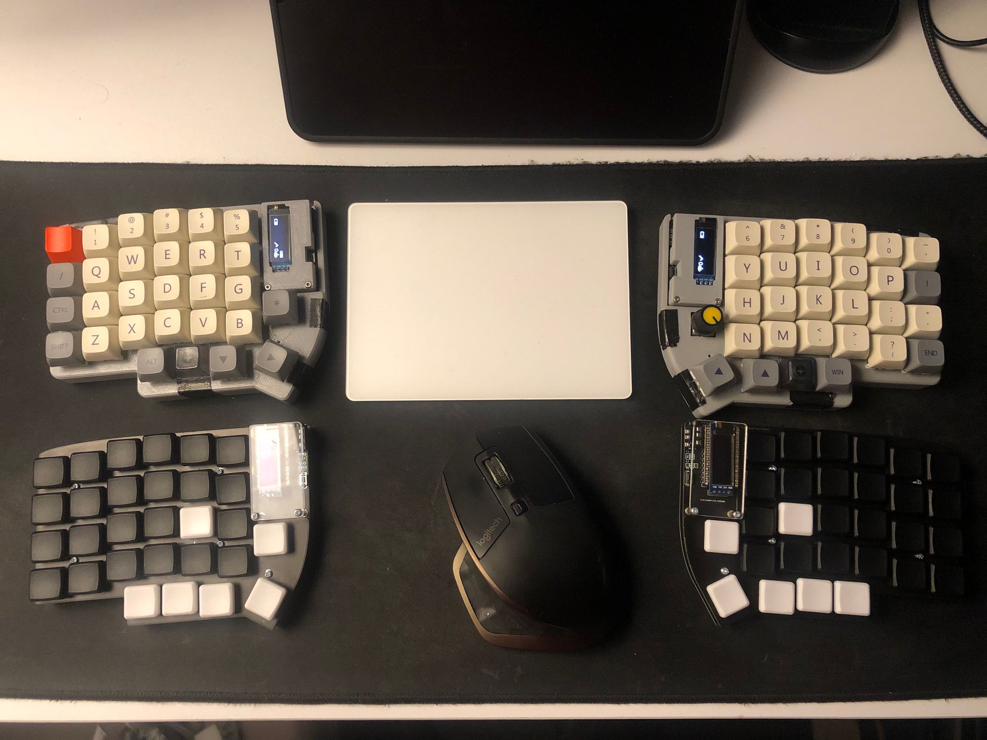 Old vs New: Both Lily58L and Lily58 Pro (Choc) with mouse and trackpad on a large mouse mat